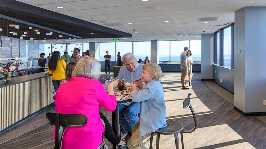 Visitors dining at Sky View Observatory cafe with panoramic city views.