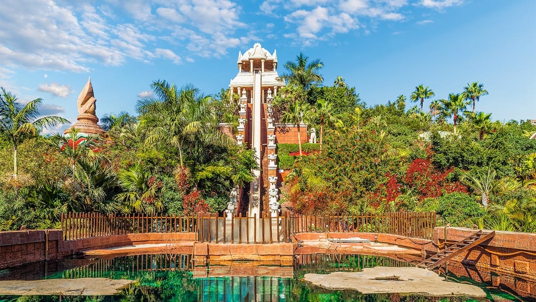 Tower of Power water slide at Siam Park, surrounded by lush greenery, Tenerife, Spain.