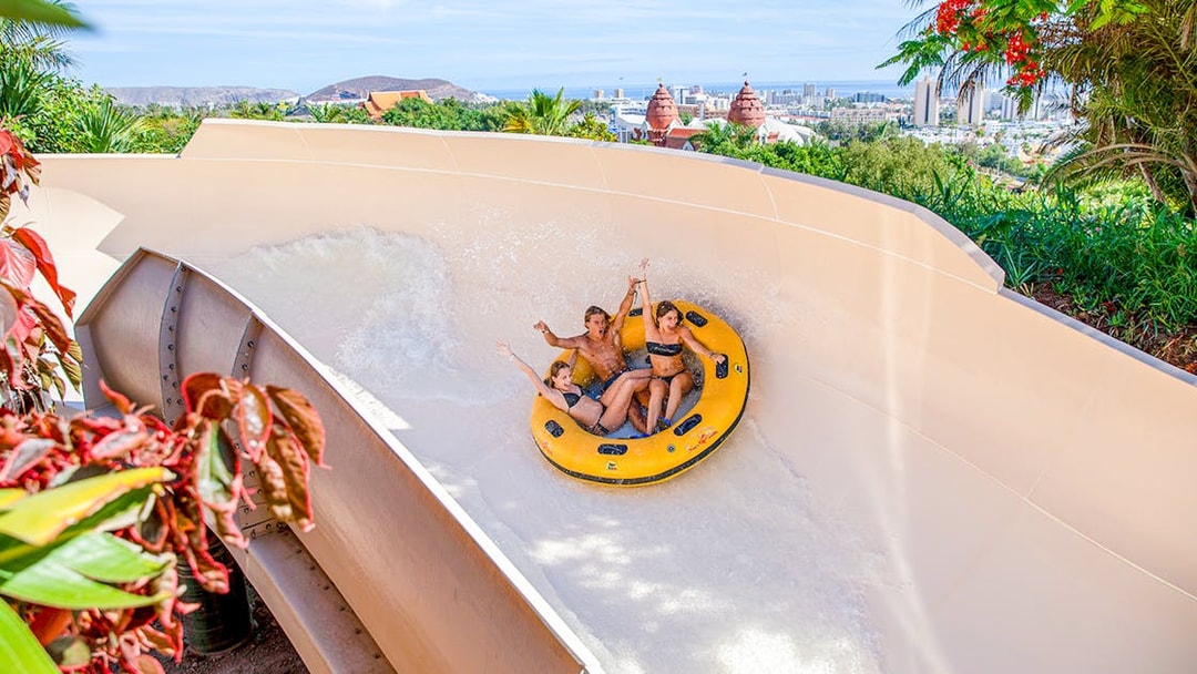 Giant tire ride at Siam Park, Tenerife with people enjoying the water slide.