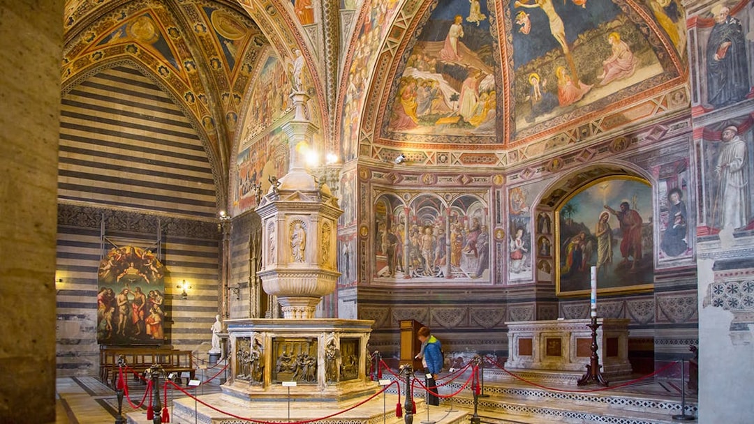 Interior of Siena Cathedral with frescoes and ornate baptismal font, Siena & Val D'Orcia Pass.