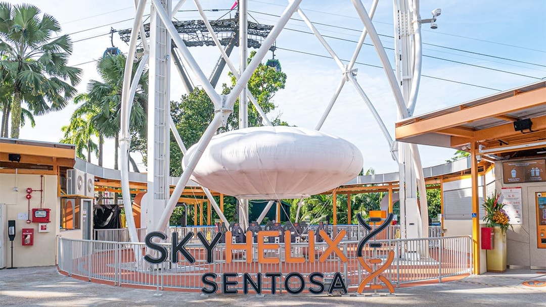 SkyHelix Sentosa ride structure with surrounding greenery in Singapore.