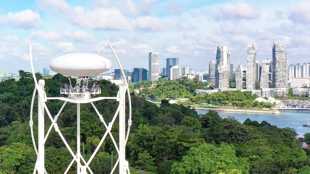 SkyHelix Sentosa ride with panoramic view of Singapore skyline and lush greenery.