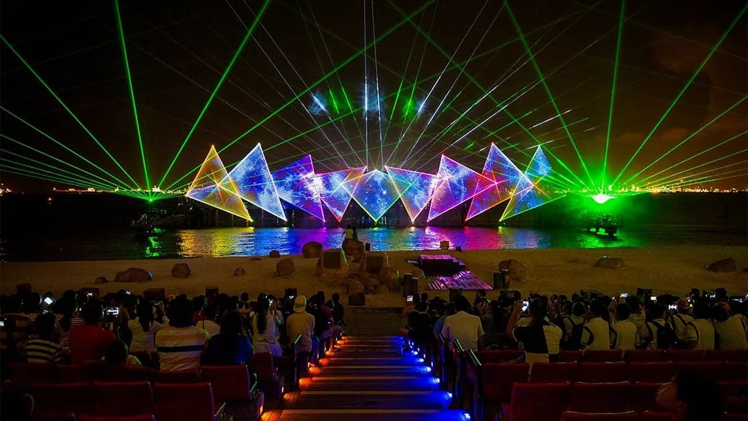 Tourists watching the Wings of Time light and sound show at Sentosa Island, Singapore.