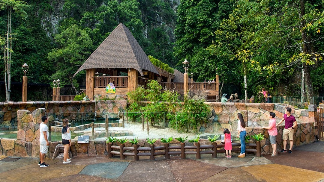 Visitors exploring Sunway Lost World of Tambun's animal exhibit in Malaysia.