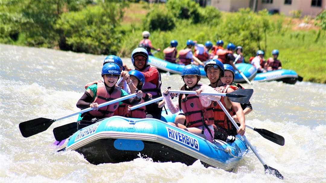 Group rafting on Kampar River, Malaysia, during 4-hour white water adventure.