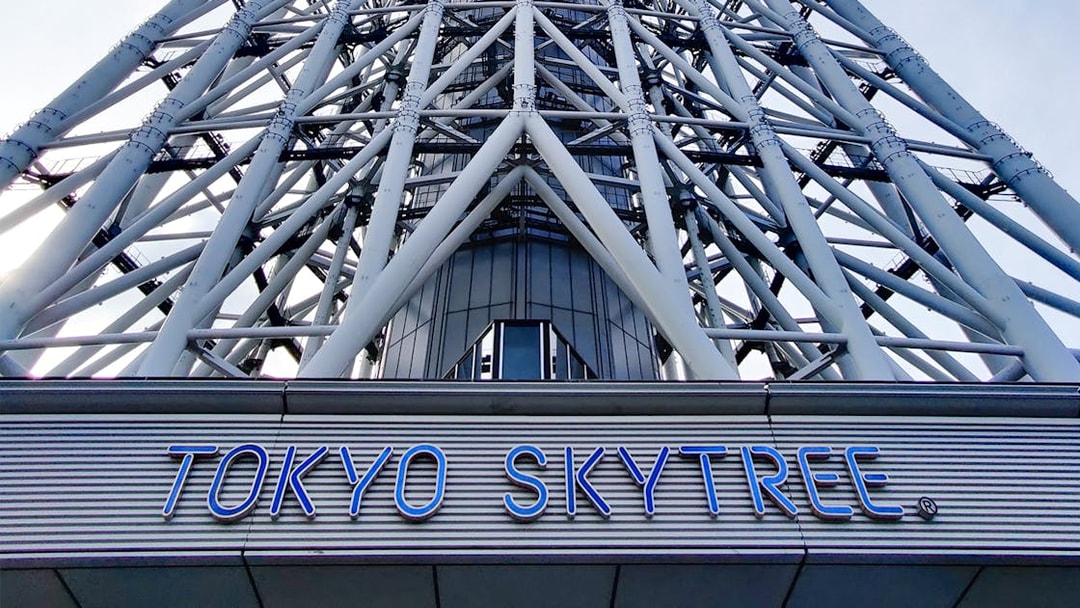 Tokyo Skytree base with structural beams and sign.