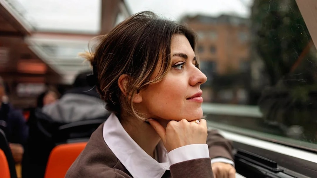 Woman enjoying view on Amsterdam canal cruise.