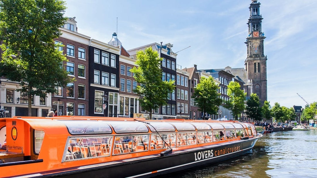 Canal cruise passing Westerkerk Church in Amsterdam.