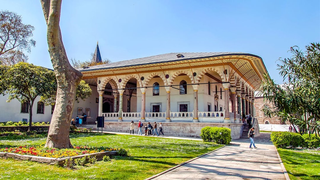Entrance to Harem and Garden of Topkapi Palace, Istanbul, with visitors exploring.