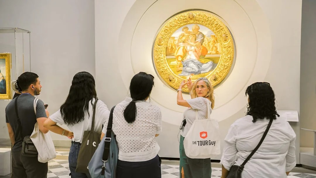 Guide explaining artwork to visitors in a gallery.