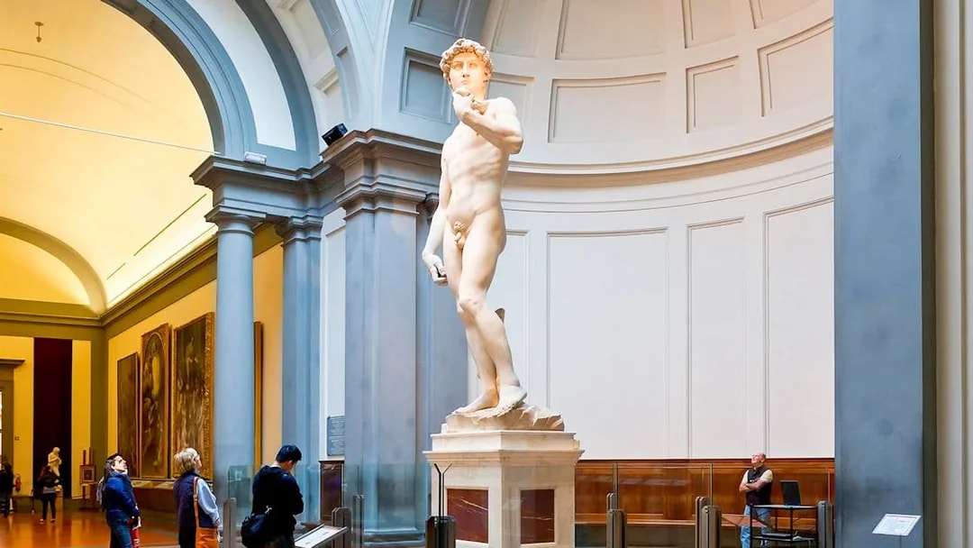 Visitors viewing Michelangelo's David in Hall of the Tribune, Accademia Gallery, Florence.