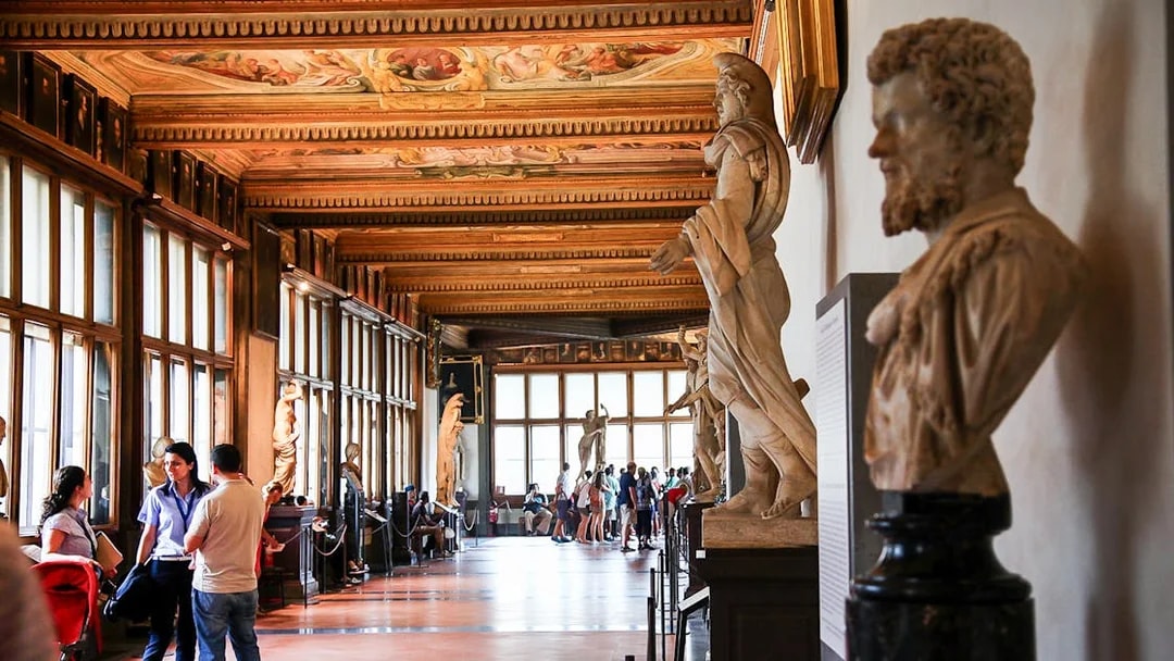 Visitors exploring statues in the Uffizi Gallery, Florence.