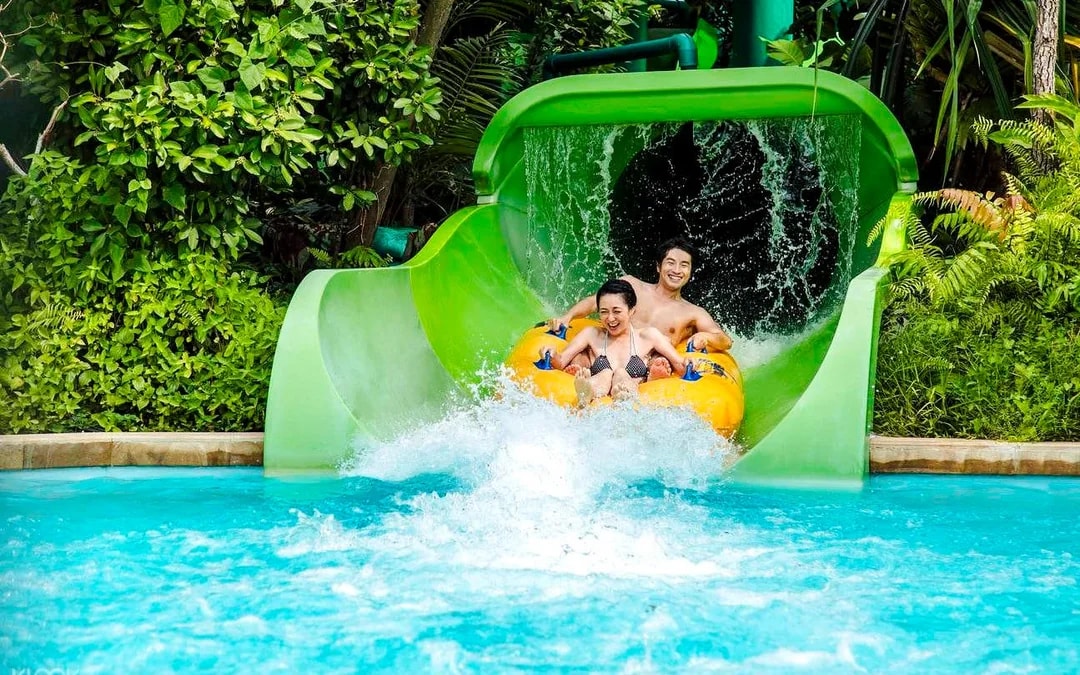 Visitors enjoying a water slide at Adventure Cove Waterpark, Singapore.