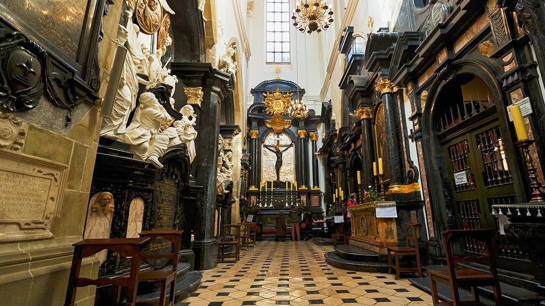 Interior of Wawel Cathedral with ornate altar and sculptures in Kraków, Poland.