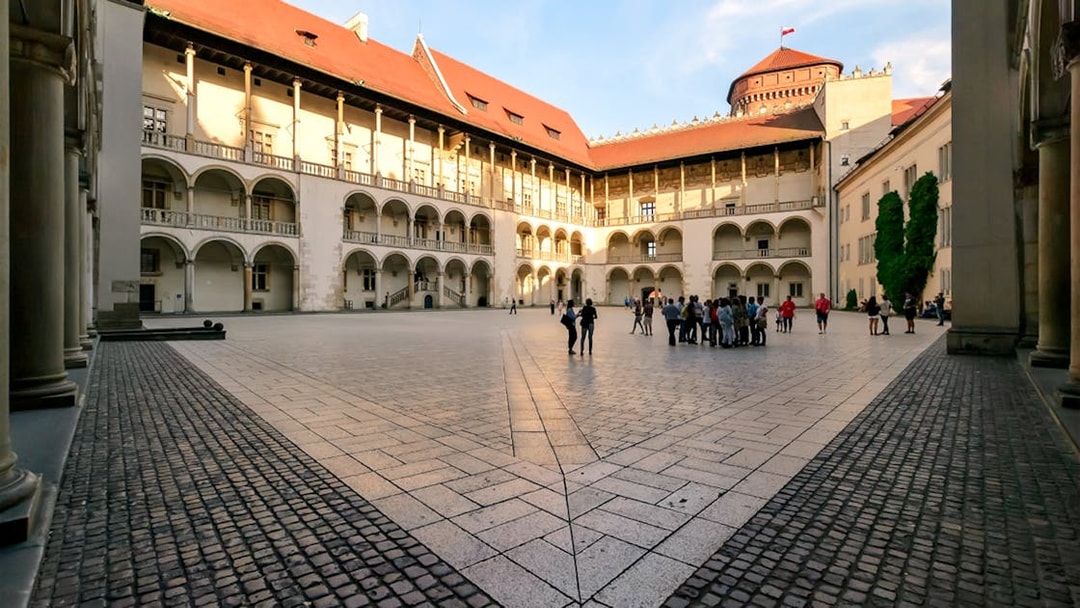 Wawel Castle courtyard with a group of tourists, Krakow, Poland.