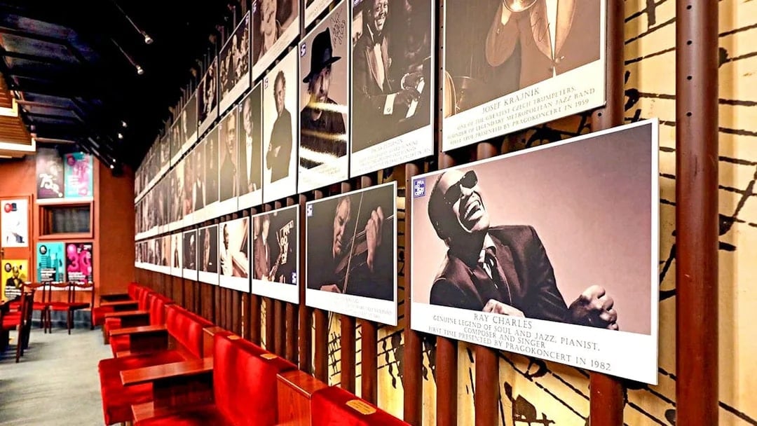 Wall of jazz musician portraits at Reduta Jazz Club interior.