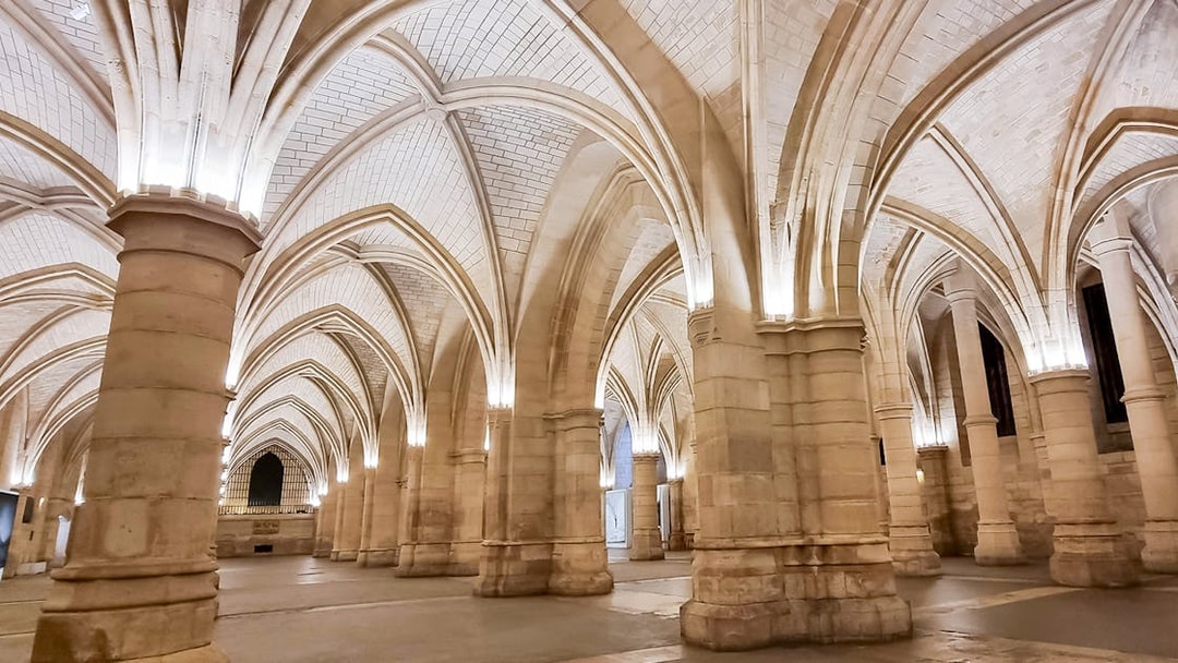 Conciergerie interior with vaulted ceilings and stone columns in Paris.
