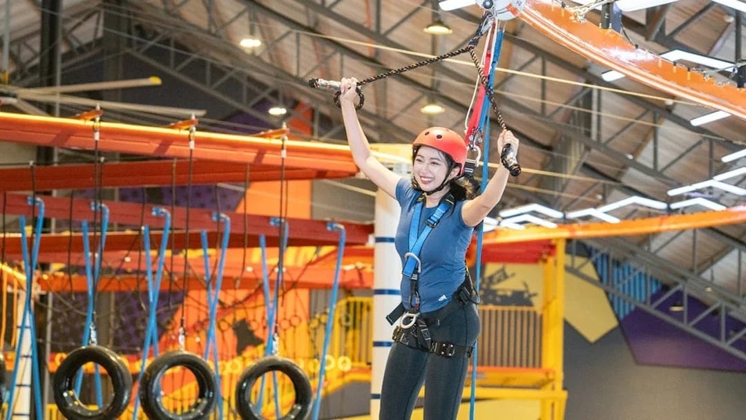 Person enjoying a ropes course at Monkey Canopy Resort's Indoor Extreme Park.