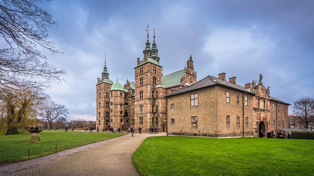 Rosenborg Castle in Copenhagen with visitors exploring the grounds.