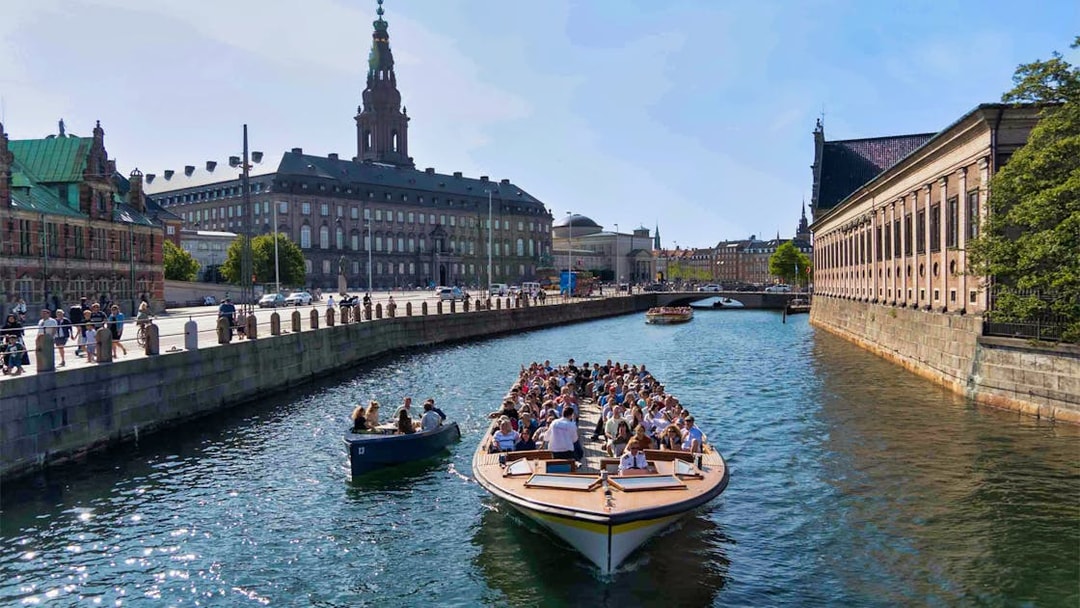 Boat tour on Copenhagen canal near Christiansborg Palace.
