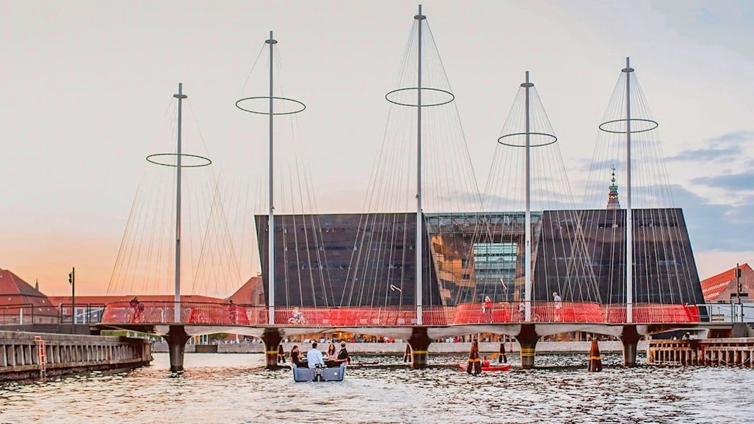 Circle Bridge over Copenhagen Harbor with cityscape backdrop.