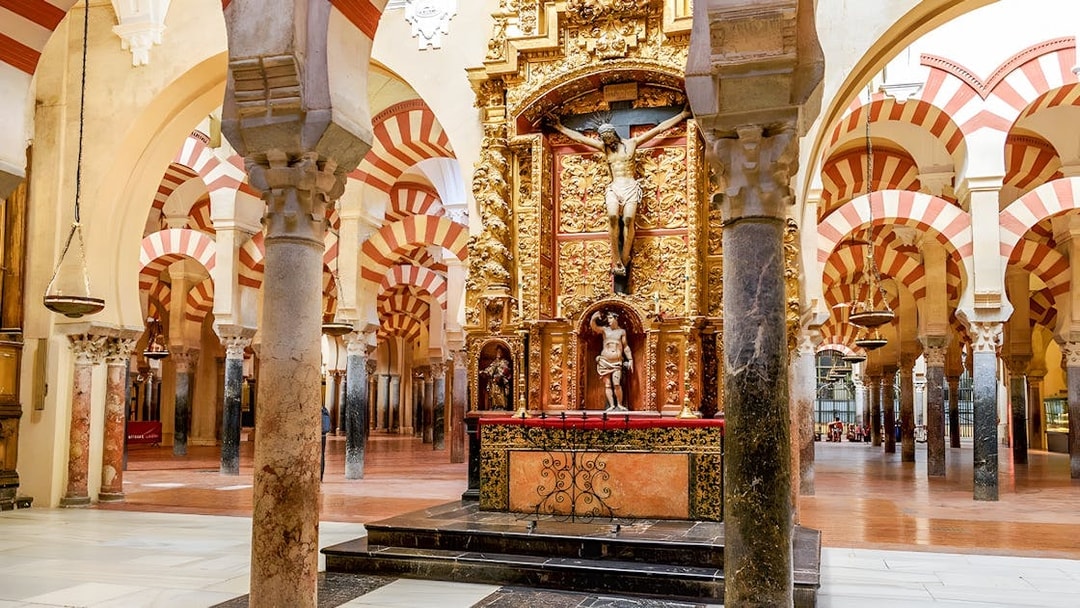 Jesus altar inside Cordoba Cathedral and Mosque with ornate arches and columns.