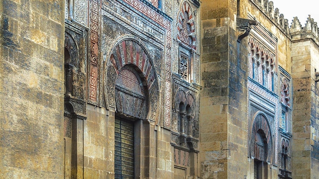 Exterior of the Great Mosque of Cordoba with intricate arches and stonework.