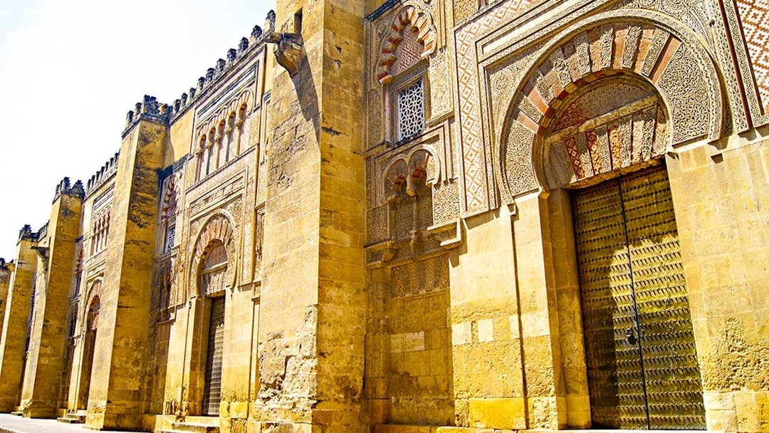 Exterior of the Great Mosque of Cordoba with intricate arches, seen on a day trip from Granada.