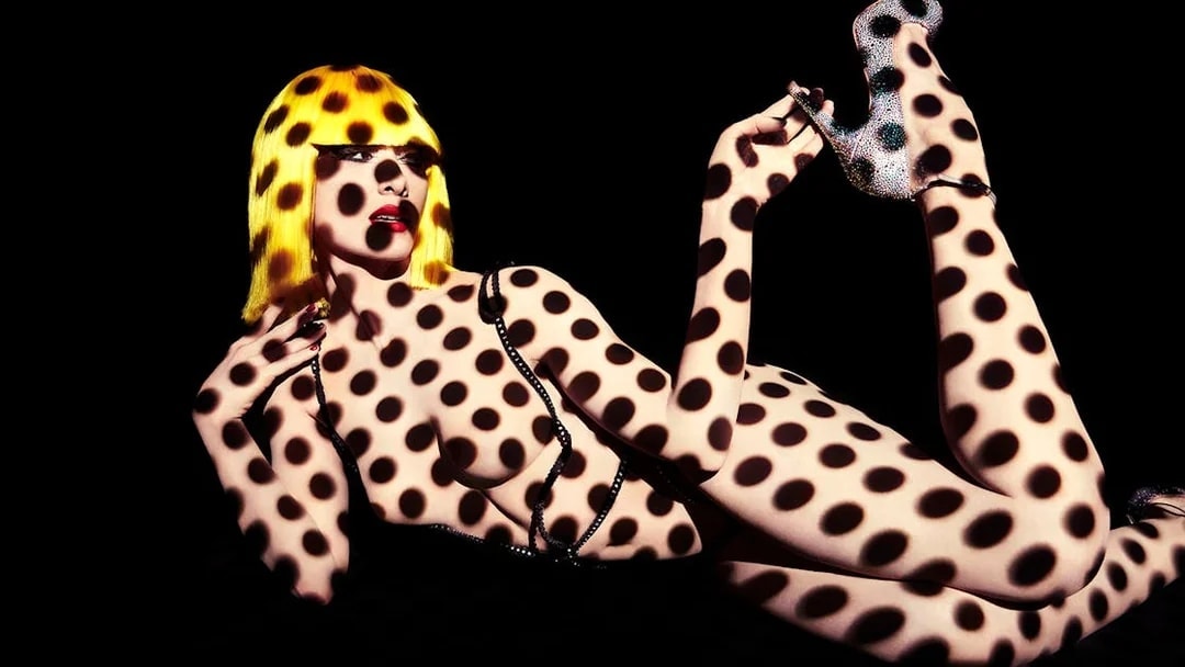 Performer with polka dot projection at Crazy Horse Show, Moulin Rouge, Paris.