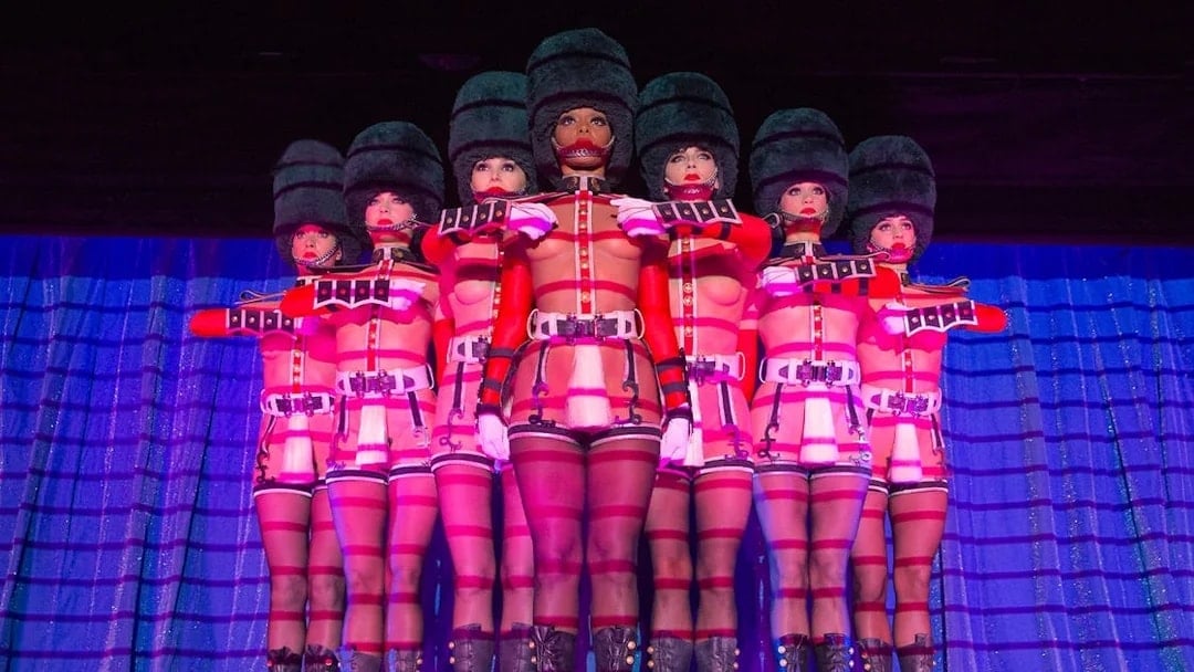 Performers in uniform costumes at Crazy Horse Cabaret Show, Paris.