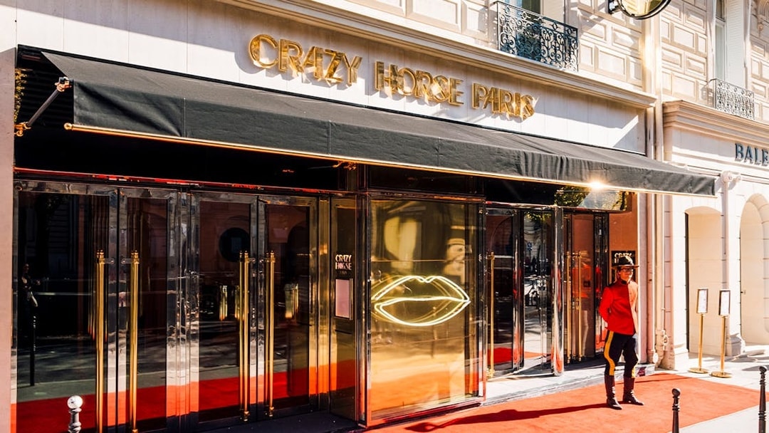 Crazy Horse Paris entrance with red carpet and doorman.