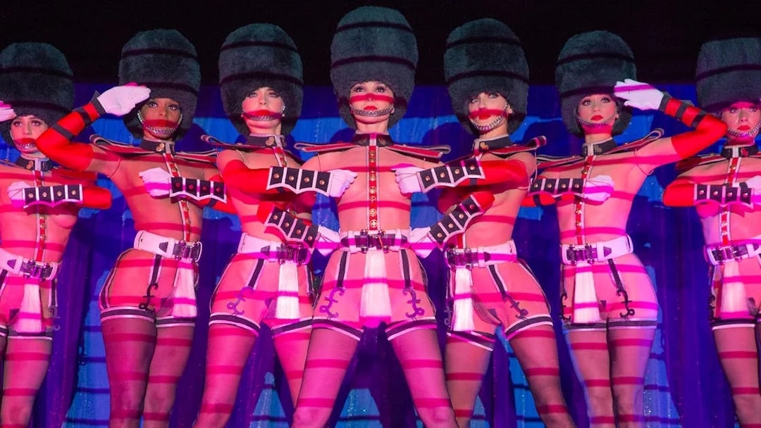 Performers in uniform costumes at Crazy Horse Cabaret Show, Paris.