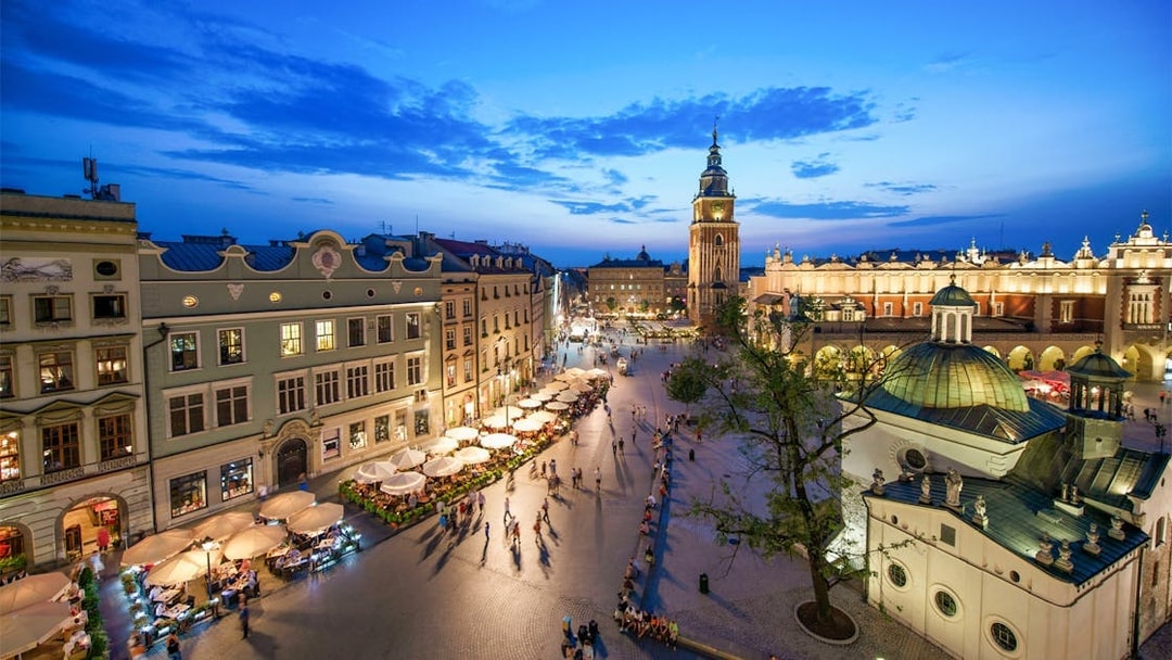 Krakow Main Square at dusk with St. Mary's Basilica and Cloth Hall, view from above.