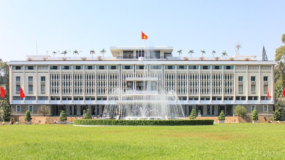 Independence Palace in Saigon, Vietnam with fountain and green lawn.