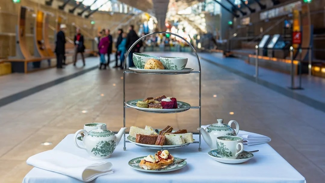 Afternoon tea setup with pastries and sandwiches at Cutty Sark, London.
