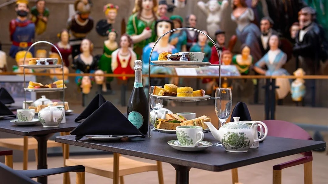 Afternoon tea setup with sandwiches and pastries at Cutty Sark, Greenwich.