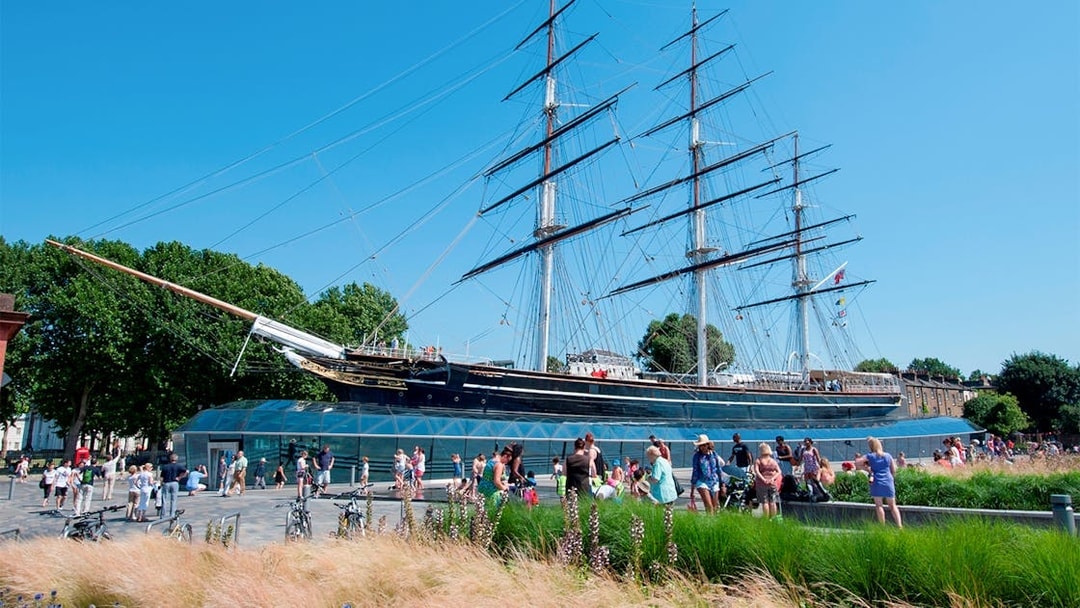 Cutty Sark ship at National Maritime Museum, London, with visitors nearby.