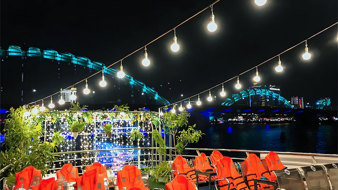 My Xuan Cruise deck on Han River at night with city lights and bridge in view.