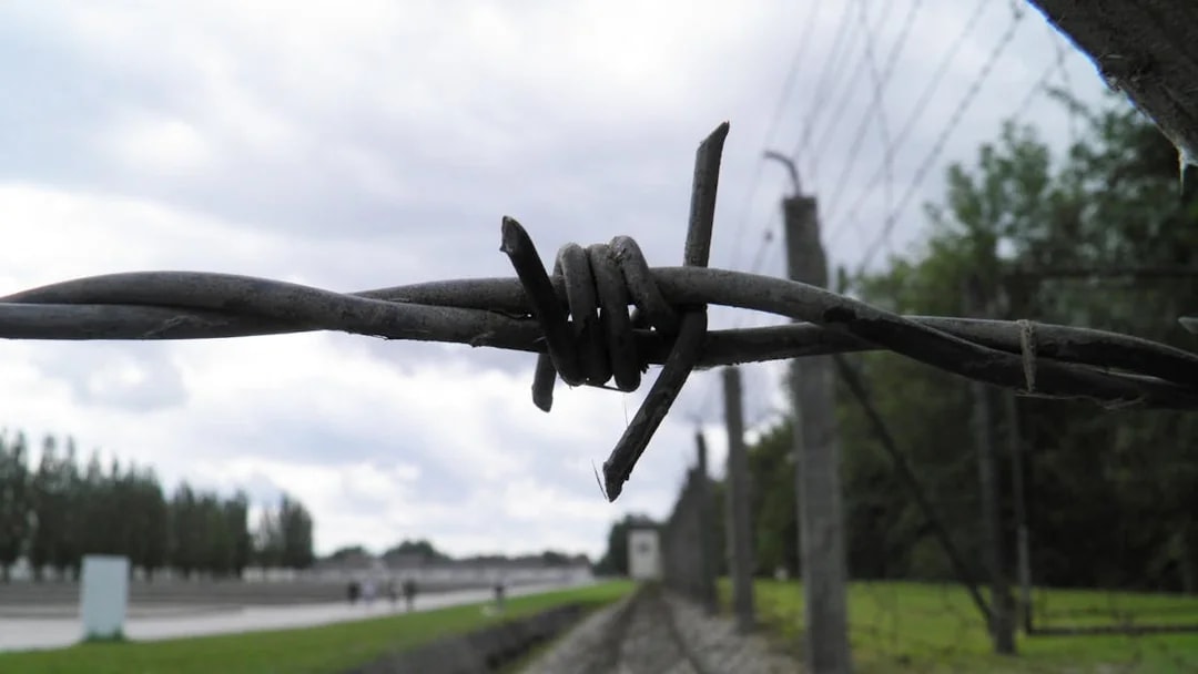 Barbed wire fence at Dachau Concentration Camp Memorial Site, Germany.