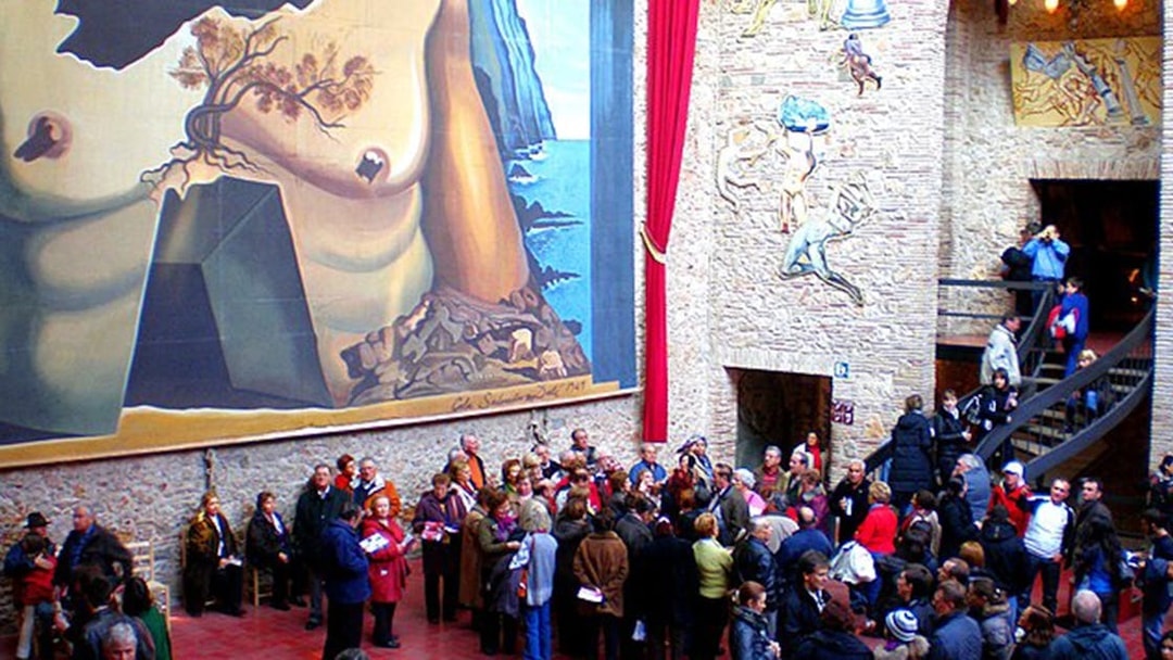 Visitors at Dalí Theatre-Museum in Figueres, viewing surrealist murals and art.