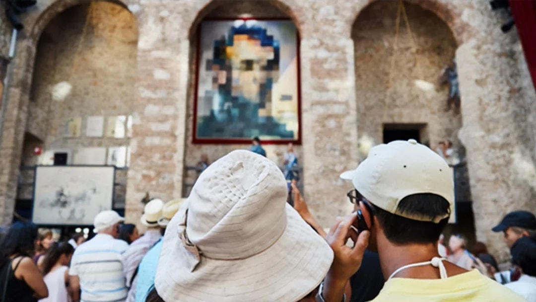 Visitors at Dalí Theatre-Museum in Figueres viewing artwork.