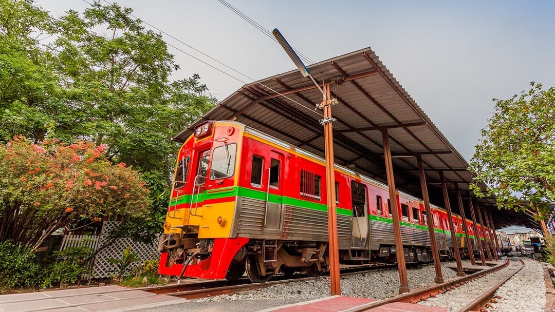 Train passing through Maeklong Railway Market, Thailand.
