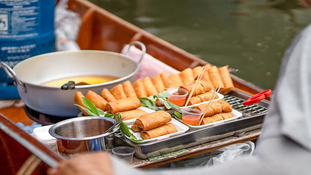 Spring rolls on a boat at Damnoen Saduak Floating Market, Thailand.