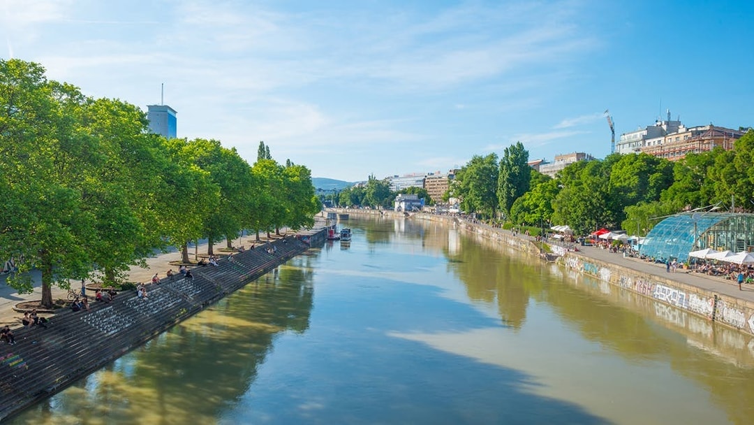 Donaukanal Danube Canal in Vienna, Austria, with people relaxing on the banks.