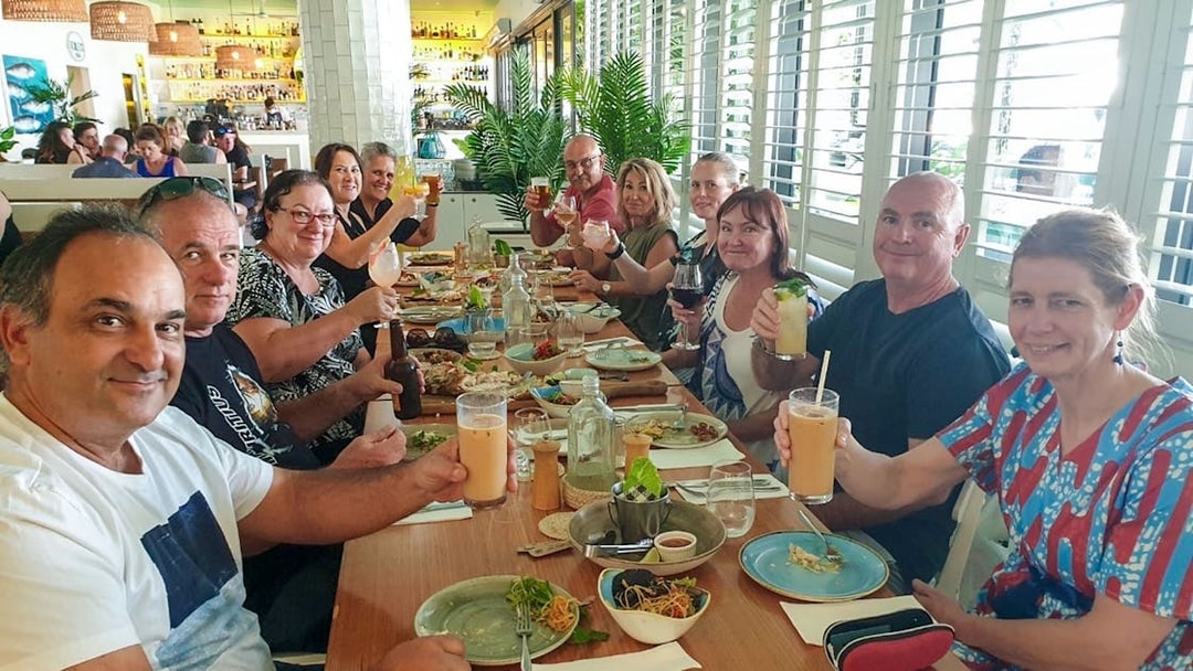 Group enjoying a gourmet meal at a restaurant during a 3.5-hour lunch or dinner art tour.