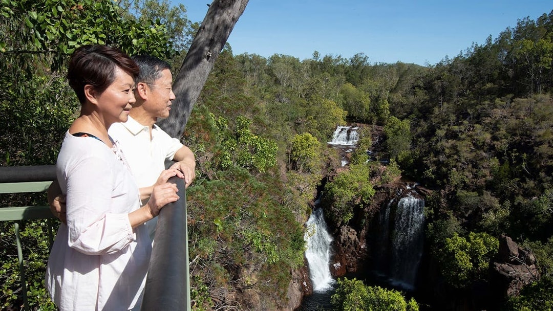 Couple enjoying waterfall view at Litchfield National Park, Darwin day tour.