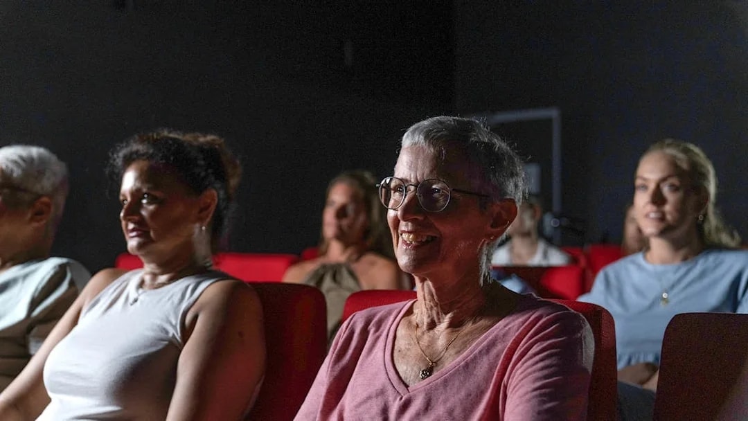 Visitors seated in a theater at the Darwin Royal Flying Doctor Service experience.