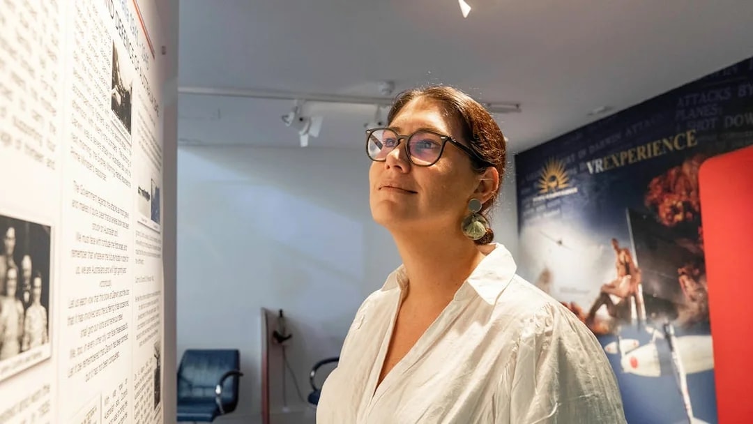 Visitor exploring exhibit at Darwin Royal Flying Doctor Service museum.