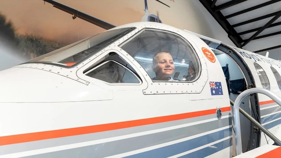 Child inside Royal Flying Doctor Service plane exhibit in Darwin, Australia.