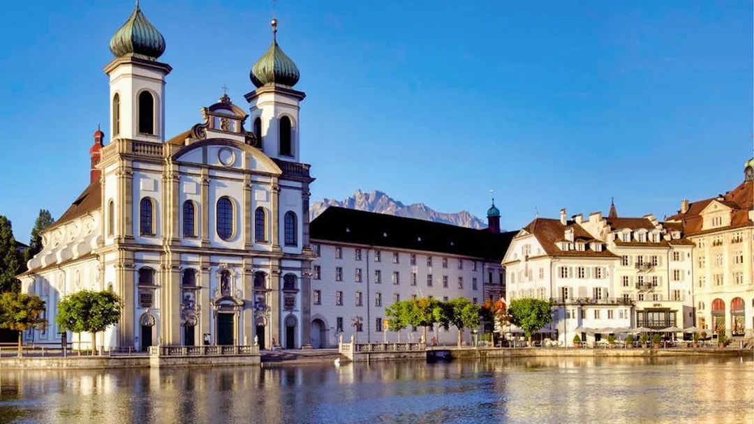 Jesuit Church in Lucerne by the Reuss River, seen on a day trip from Zürich with yacht cruise.